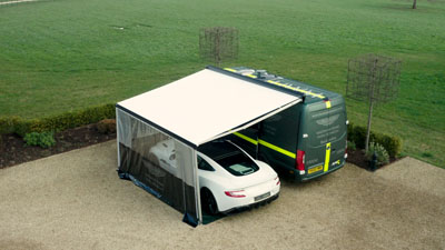 Van awning over Aston Martin